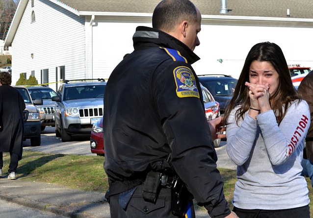 A woman waits to hear about her sister, a teacher, following the shooting at the Sandy Hook Elementary School in Newtown